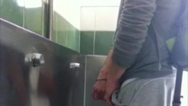 GUY STROKING AT THE URINAL